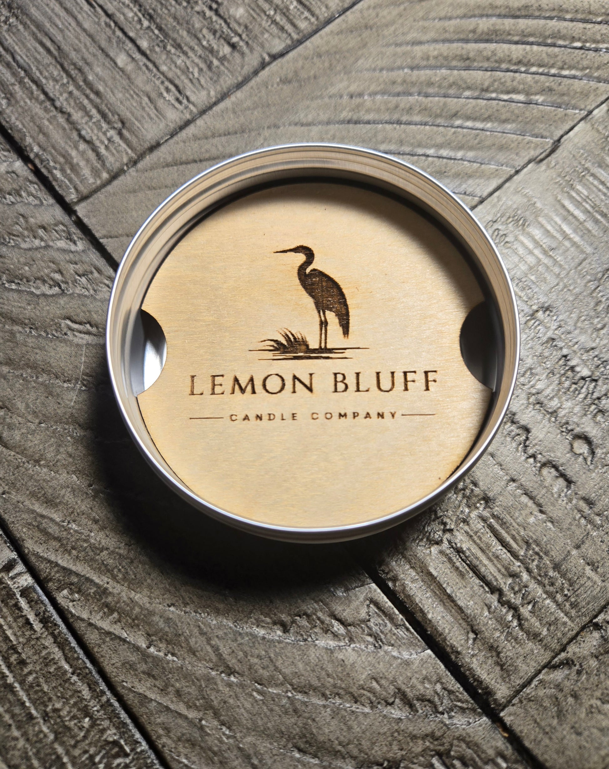 A picture of a LBCC logo on a wood car freshener in a silver, gold or black tin.